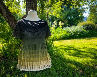 May include: A crocheted top with a green and yellow ombre design. The top has a crochet lace trim and a cutout detail at the neckline.