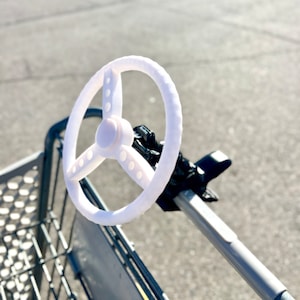 Clip on toy steering wheel wagon accessory for shopping carts strollers and wagons