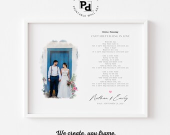 May include: A framed print featuring the lyrics to "Can't Help Falling in Love" by Elvis Presley. The print includes a photo of a couple in front of a blue door, with the names Nathan & Emily and the date September 21, 2021.