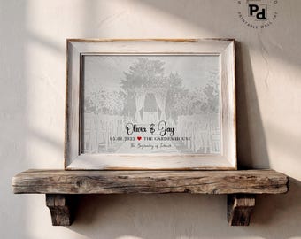 May include: A rectangular framed print featuring a grayscale illustration of a wedding ceremony setup with an archway and chairs. The text reads Olivia & Jay, 05.01.2022, a red heart icon, THE GARDEN HOUSE, and The Beginning of Forever.