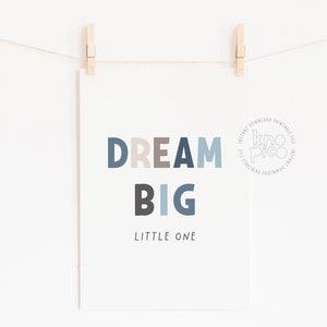 May include: A printable wall art print with the text "DREAM BIG LITTLE ONE" in a blue, gray, and beige color scheme. The print features a circular logo with the text "kno pico" in the center.