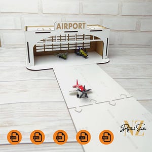 May include: White wooden model of an airport hangar with a runway. The hangar has a sign that says "AIRPORT". There are three small toy airplanes inside the hangar and one on the runway. The model is available in CDR, SVG, DXF, AI, and PDF formats.