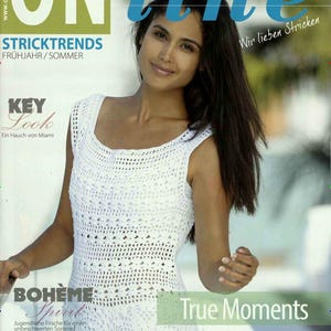 May include: A woman wearing a white crocheted dress with a keyhole neckline. The magazine cover features the text "ONline" and "STRICKTRENDS" in large, bold letters. The text "True Moments" is also visible in the lower right corner of the image.
