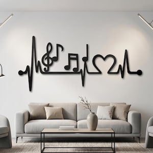May include: A black wall-mounted decoration featuring a continuous heartbeat line that incorporates a treble clef, a musical note, and a heart shape. The design is composed of thin, flat lines and symbols arranged horizontally to form a single graphic.