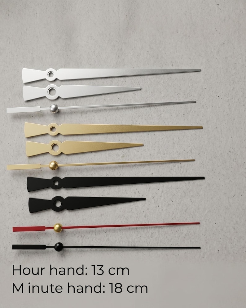 May include: Assortment of clock hands in silver, gold, black, and red. The hour hand is 5.1 inches long, and the minute hand is 7.1 inches long. The hands have a variety of shapes and include a small ball or circle at the base.
