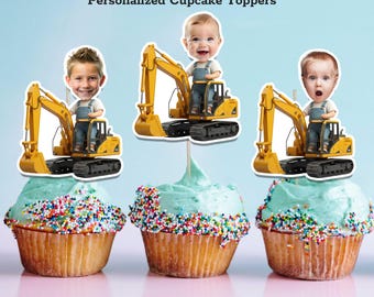May include: Three cupcakes with blue frosting and colorful sprinkles. Each cupcake is topped with a personalized excavator-themed cake topper featuring a child's face. The text "Personalized Cupcake Toppers" and "Print And Cut Out" are visible.