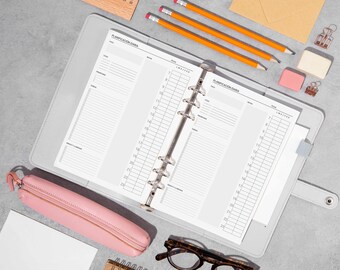 May include: A gray planner with a white interior and the text "Planificación Diaria" on the cover. The planner is open to a daily schedule page with a time scale from 7 am to 9 pm. The planner is surrounded by various office supplies, including pencils, a pink pencil case, a pink eraser, and a silver binder clip.