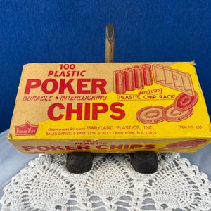 May include: A vintage box of 100 plastic poker chips. The box is yellow and tan with red lettering that reads "POKER CHIPS." The box also features a graphic of poker chips and a chip rack. The item number is 100.