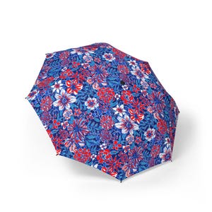 May include: An open umbrella with a vibrant floral pattern. The design features red, white, and blue flowers and foliage against a dark blue background. The umbrella is fully extended, showcasing the intricate details of the print.