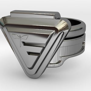 May include: A silver ring with a triangular design featuring a stylized butterfly and the letter "E".