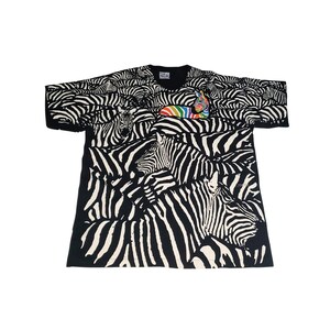May include: Black t-shirt with a zebra print design. The shirt features a repeating pattern of zebras in black and white. A rainbow-colored zebra is on the front of the shirt. The shirt has short sleeves and a crew neck.