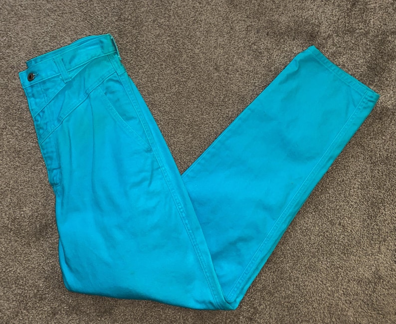 May include: A pair of turquoise blue trousers. The trousers have a straight leg and a high waist.