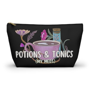 May include: Black zippered pouch with a pink teacup and a blue potion bottle. The text "Potions & Tonics (My Meds)" is printed on the pouch.