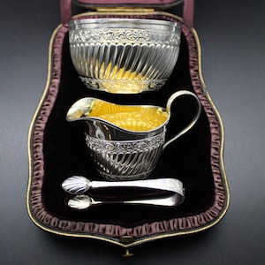 A Boxed Set of Victorian Silver Gilt Sugar Bowl, Cream Jug & Sugar Tongs