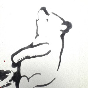 May include: A minimalist black ink line drawing of a bear sitting and looking upward. The bear is depicted with simple, fluid strokes on a white background, with a small red dot near the bottom left corner and a partial black shape above.
