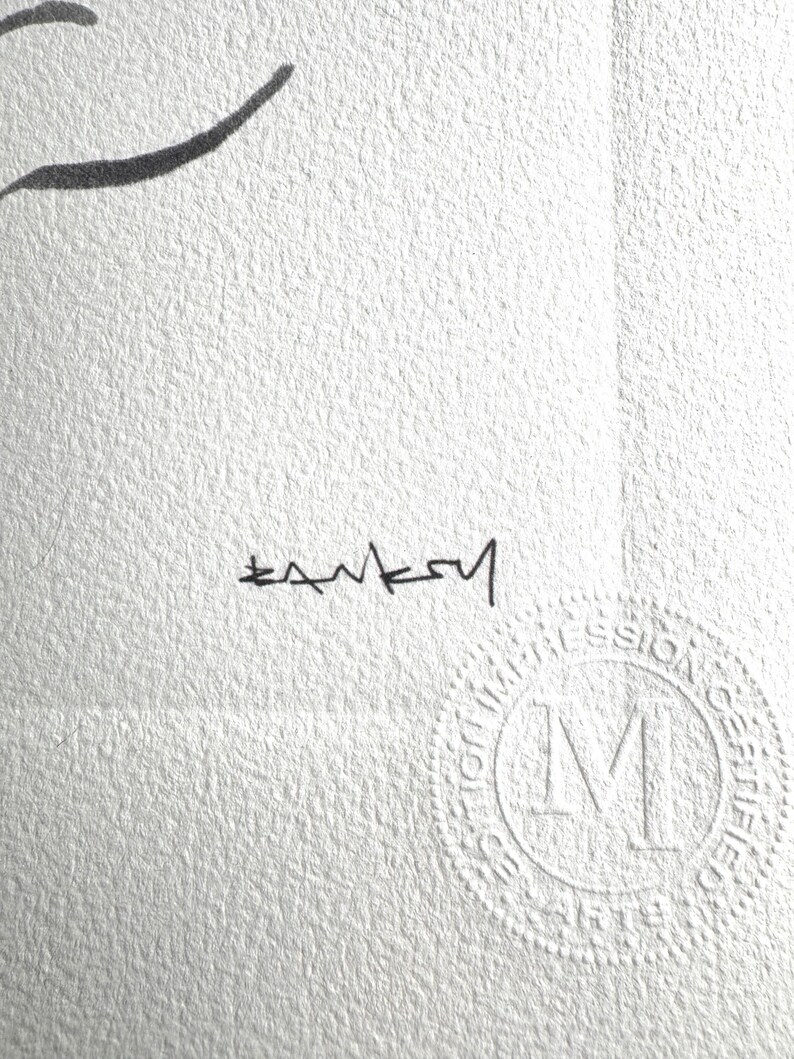 May include: A white textured paper print featuring a black ink signature that reads Banksy. In the lower right corner, there is a circular embossed stamp with the letter M in the center and the text Impression Certifiee surrounding it.