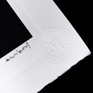 May include: A white textured paper print with a black rectangular area. The paper features a hand-signed signature in black ink and a circular embossed stamp that reads "EDITION IMPRESSION CERTIFIEE" with a large letter M in the center.