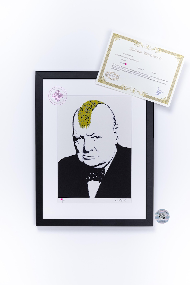 May include: A framed print featuring a stylized black and white portrait of Winston Churchill with a gold mohawk hairstyle. The artwork includes a circular stamp, a signature, and a separate rectangular certificate of authenticity with gold borders.