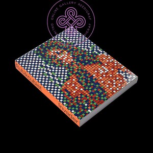 May include: A book titled "Invader" by "Rubikcubist" with a colorful pixelated cover design. The book is closed and lying on a black surface.