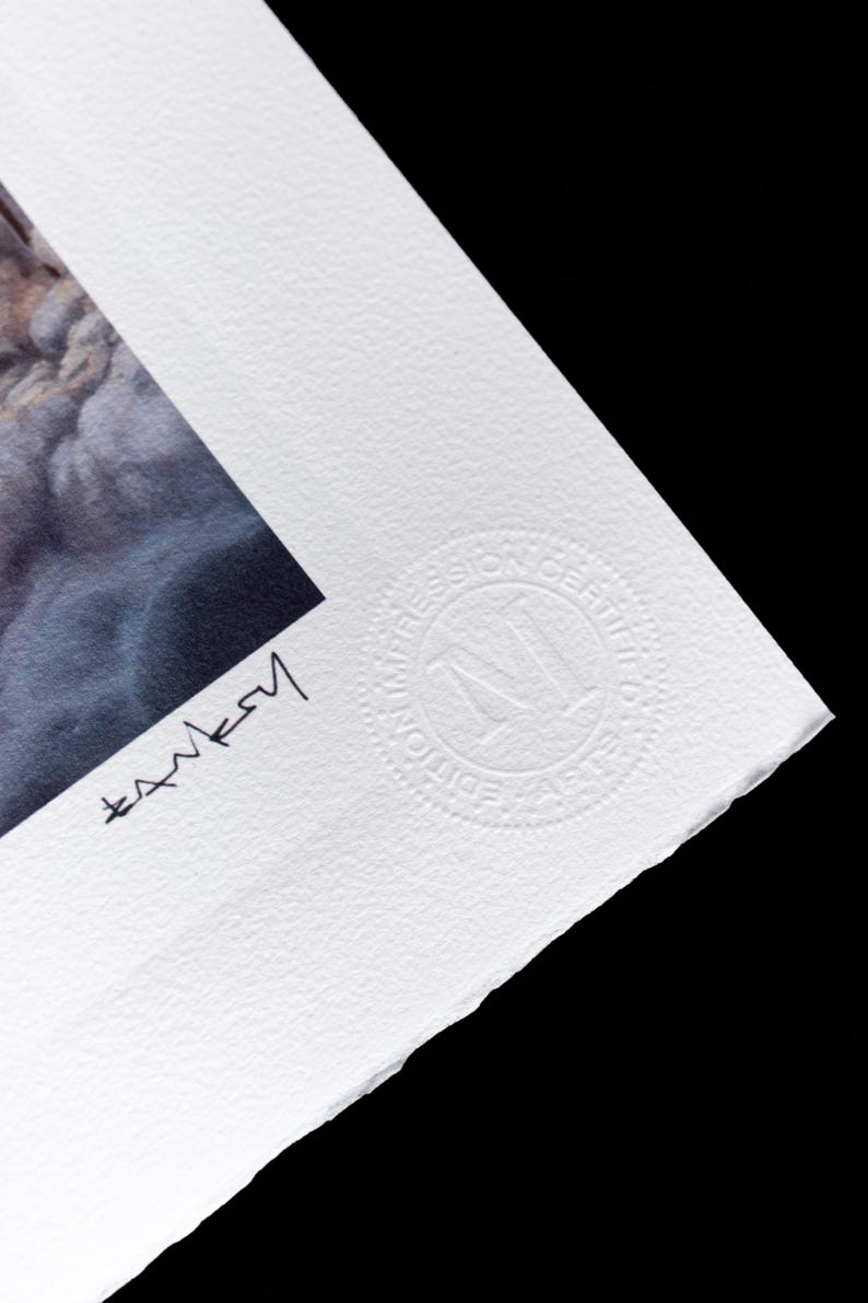May include: A white paper art print featuring a dark, textured illustration in the corner. The print includes a black handwritten signature and a circular embossed seal that reads "EDITION IMPRESSION CERTIFIEE ARTS" with an "M" in the center.