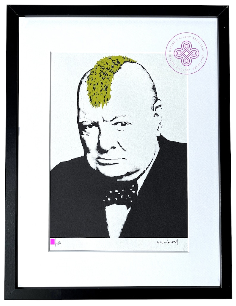 May include: A framed print featuring a high-contrast black and white portrait of Winston Churchill with a bright olive green mohawk hairstyle. The artwork includes a small pink square, a signature, and a circular logo in the top right corner.