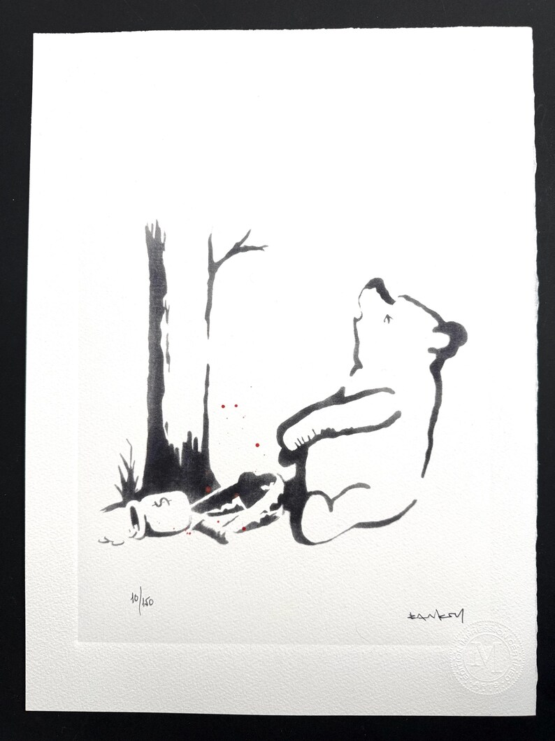 May include: A black and white ink illustration on textured paper depicting a bear sitting next to a tree with a honey pot marked with a dollar sign. The print features the handwritten text 10/150 and a signature, with small red paint splatters.