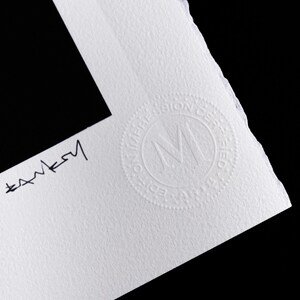 May include: A white textured paper print with a deckled edge featuring a black handwritten signature that reads Banksy. A circular embossed stamp is visible on the paper, containing the letters MD and the text EDITION IMPRESSION CERTIFIED.
