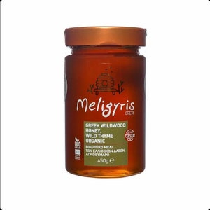May include: A glass jar of Meligyris Greek Wildwood Honey, Wild Thyme Organic honey. The jar is labeled with a beehive logo and the text "Great Taste". The jar is 450g.