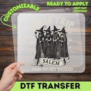 May include: A clear DTF transfer sheet featuring a black graphic of four witches in pointed hats standing together. The text reads GIRLS TRIP, SALEM, and TIME TO GET WICKED. The design includes small bat silhouettes and intricate gown details.