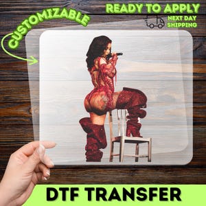 A hand is pointing at a transparent sheet with a picture of a woman wearing a red sequined outfit and high heels.