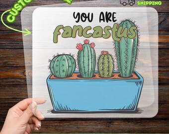 May include: A DTF transfer featuring a blue rectangular planter with four green cacti. The text "YOU ARE fancastus" is above the cacti. The words "CUSTOMIZABLE" and "READY TO APPLY" are also present.