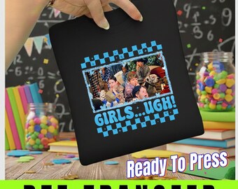 May include: Black t-shirt with a blue and white checkered border around a photo of a group of people. The text "GIRLS...UGH!" is in blue. The words "Ready To Press" and "DTF TRANSFER" are also visible.