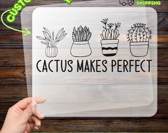 May include: A clear DTF transfer sheet featuring four potted plant illustrations and the text "CACTUS MAKES PERFECT" in black. The sheet is held against a wooden background. The words "CUSTOMIZABLE" and "READY TO APPLY" are also visible.