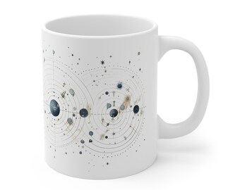 May include: White ceramic mug with a black and white illustration of a celestial design with planets, stars, and constellations.