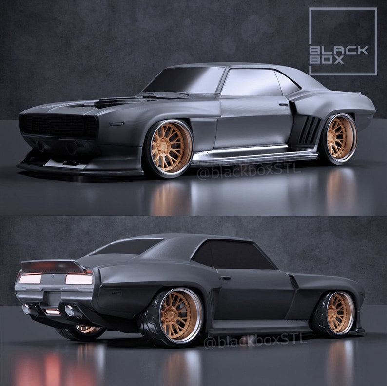May include: A matte gray custom muscle car with bronze-colored rims. The car has a low profile, a front air dam, and a rear spoiler. The image includes the text "BLACK BOX" and the Instagram handle "@blackboxSTL".