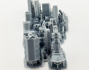May include: A gray, miniature model of an industrial complex, featuring various structures like towers, cylinders, and rectangular buildings. The model is intricately detailed, showcasing a complex arrangement of components and shapes, all in a uniform gray color.