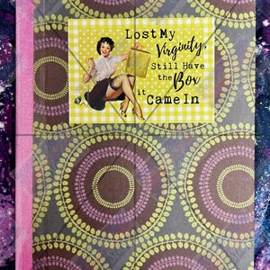 May include: A rectangular notebook with a brown and lime green circular pattern and a pink spine. A central rectangular label features a pin-up illustration of a person and the text: Lost My Virginity, Still Have the Box it Came In.