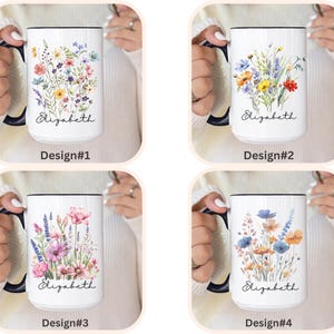 May include: Four white ceramic mugs with dark blue handles and rims, each featuring a unique watercolour wildflower bouquet and the name Elizabeth in black script. The designs are labelled Design#1, Design#2, Design#3, and Design#4 respectively.