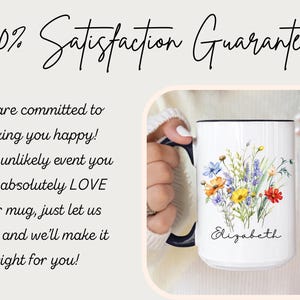 May include: A white ceramic mug with a dark blue handle and rim, featuring a colourful watercolour-style floral bouquet illustration and the name Elizabeth printed in black script. The text 100% Satisfaction Guarantee is visible above.