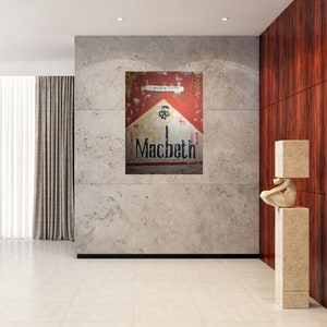 May include: A vintage-style cigarette pack in red, white and black with the word "Macbeth" printed on it. The pack is hanging on a wall in a modern interior.