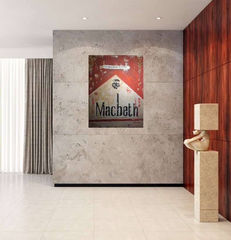 May include: A vintage-style cigarette pack in red, white and black with the word "Macbeth" printed on it. The pack is hanging on a wall in a modern interior.