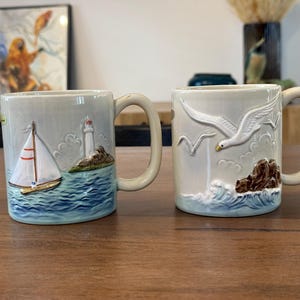 Vintage OTAGIRI Hand Painted Embossed Mug Seagull Sailboat Lighthouse | Set of 2