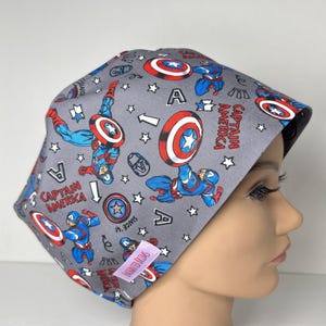 May include: A white ceramic mug with a black handle and the text "But First, Coffee" in a bold, black font. The mug is set against a neutral background, highlighting its simple design.