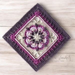 May include: A crocheted square with a floral design in shades of purple, pink, and cream. The square is surrounded by a border of purple and cream crochet stitches. The text "Art of Serendipity" and "Pam Knighton-Haenchen" is visible in the bottom right corner.
