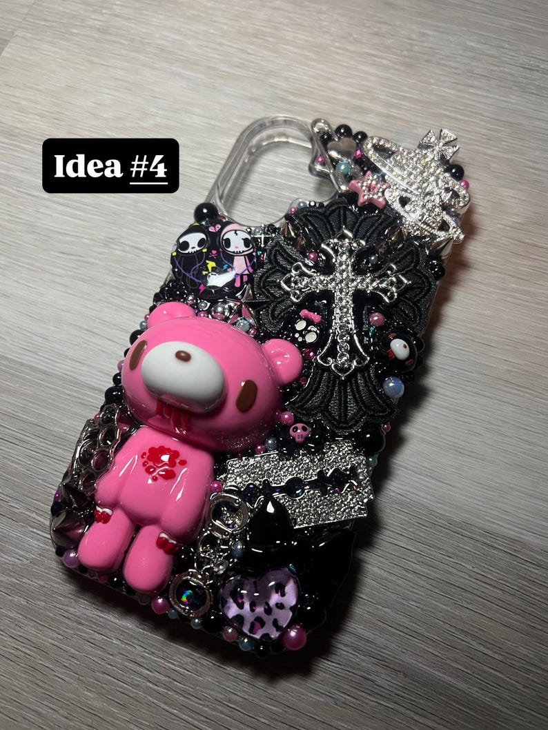 May include: A bedazzled phone case with a pink, cartoon bear figure with blood details. The case is decorated with black beads, a silver cross, and a silver razor blade. The text "Idea #4" is in a black rectangle.