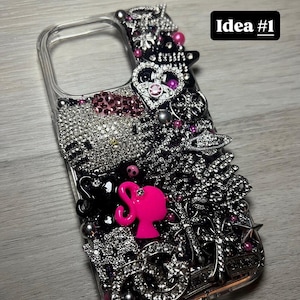 May include: Clear phone case bedazzled with rhinestones, silver embellishments, and pink accents. Features a pink silhouette and the text "Idea #1". The case is decorated with various charms and jewels.