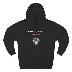 May include: Black hooded sweatshirt with the word "OBLIVIOUS" in white and red lettering across the chest. Below the text is a white graphic of a head with a brain-like design. The text "WAKE UP TO THE WORLD" is below the word "OBLIVIOUS".