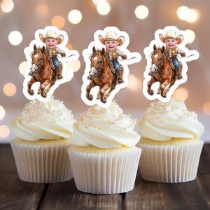 Könnte beinhalten: Drei weiße Cupcakes mit braunem Frosting und weißen Streuseln, die mit essbaren Bildern eines Kindes in einem Cowboyhut auf einem braunen Pferd verziert sind.