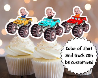 May include: Three monster truck cupcake toppers with a baby's face on each. The trucks are yellow, blue, and red. The text "Color of shirt and truck can be customized" is below the toppers.