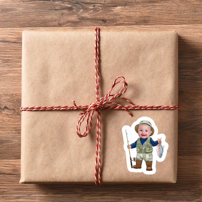 May include: A brown paper gift bag tied with a red and white twine bow. A sticker of a young boy holding a fishing rod and a fish is on the front of the bag.